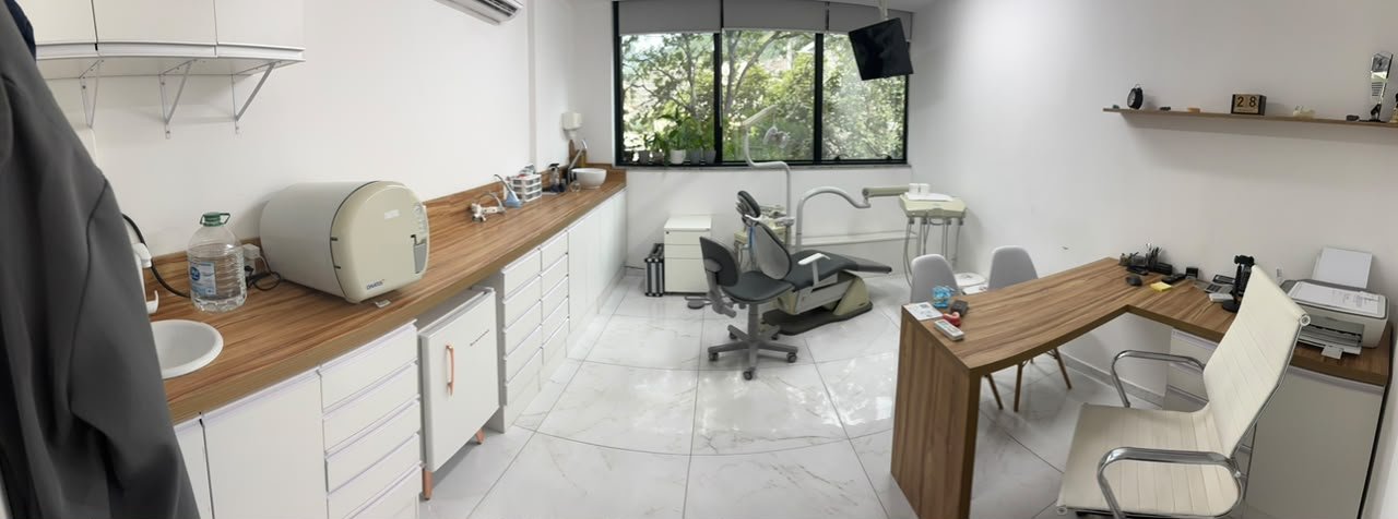 Consultório completo com cadeira odontológica, bancada e área de atendimento